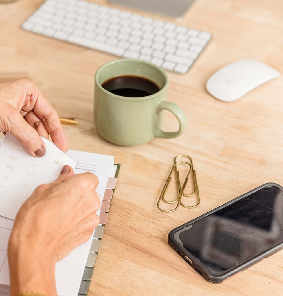 Setting up Redeem Her Time Planner at a tidy desk, ideal for Christian women in business