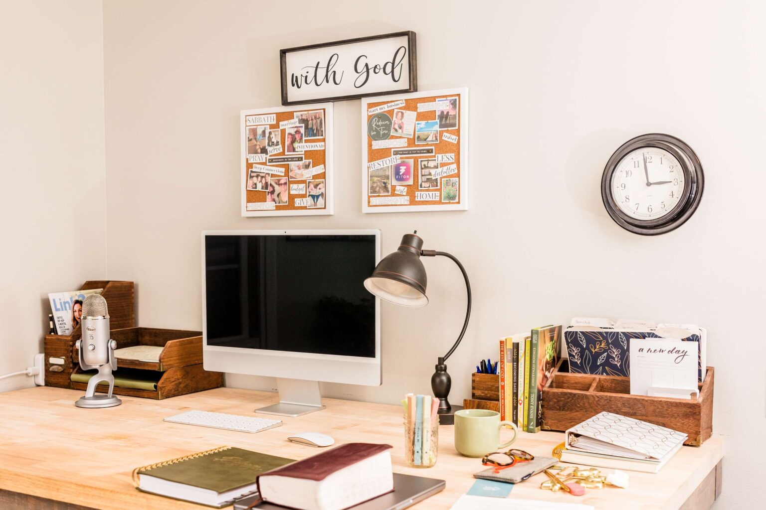Organized home office setup with Christian books, planner, and decor